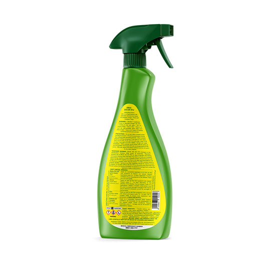 Green spray bottle with a yellow label on a white background