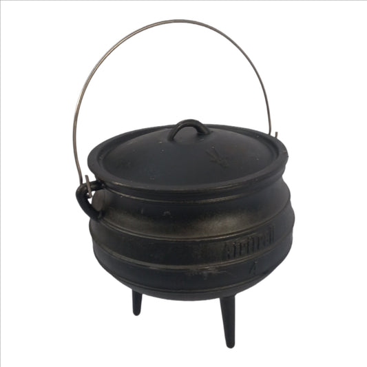 Black cast iron pot with lid on a white background