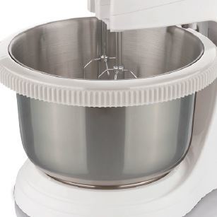 Close-up of a stand mixer with a silver bowl and whisk attachment.