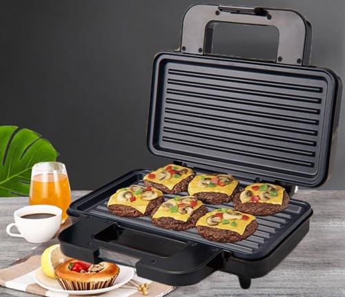 Black grill with burgers on a wooden table