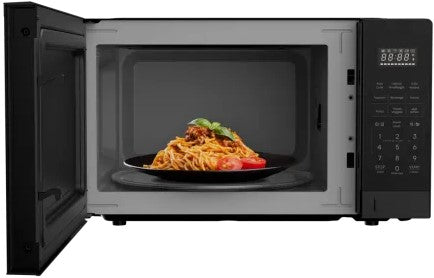 Black microwave oven with a dish of spaghetti inside, on a white background