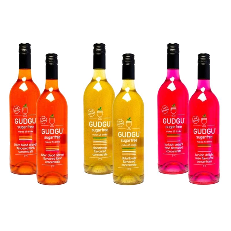 A collection of GUDGU sugar-free concentrate bottles in various colors representing different flavors.