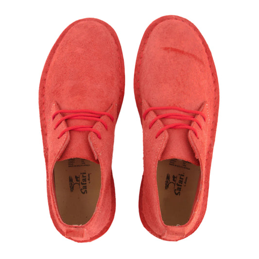 Pair of red suede shoes with red laces on a white background