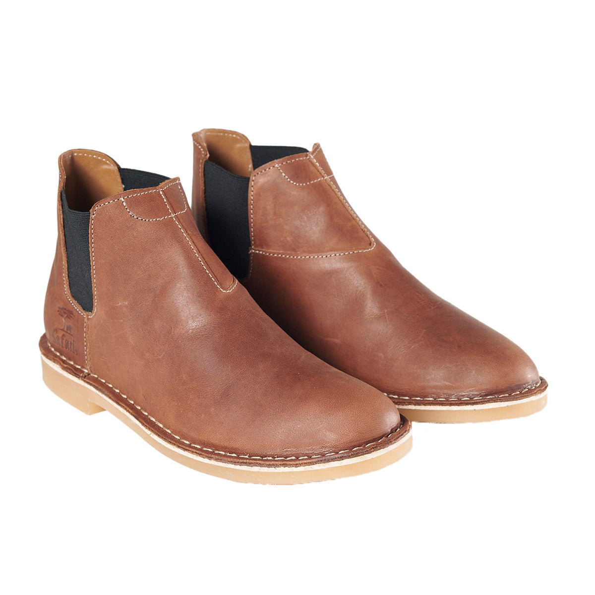 A pair of brown, waxed leather Chelsea style boots for men with a stitched down construction.