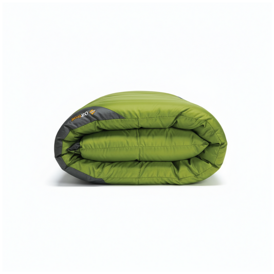 Folded green sleeping bag with black accents on a white background