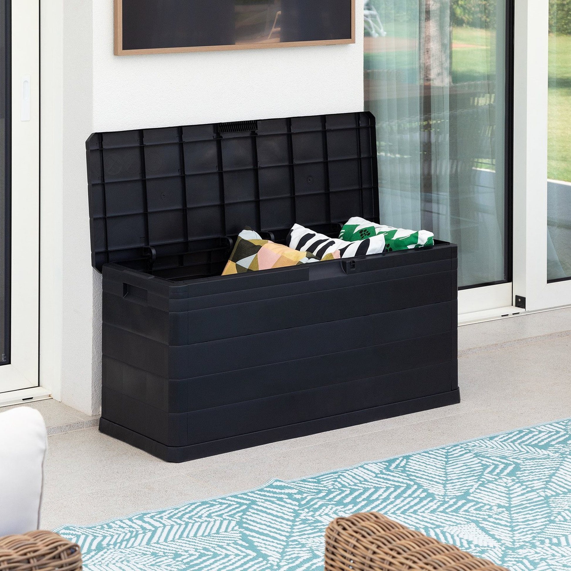 Black storage box with cushions on a patio