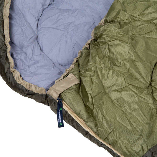Close-up of a sleeping bag with blue and green interior, featuring branding.