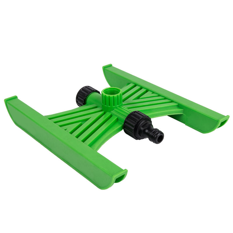 A green plastic sledge base designed to stabilize garden sprinklers.