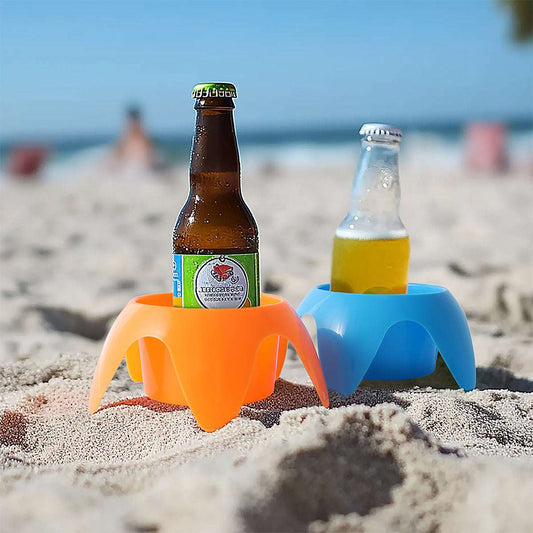 Two bottles in orange and blue bottle holders on a sandy beach.