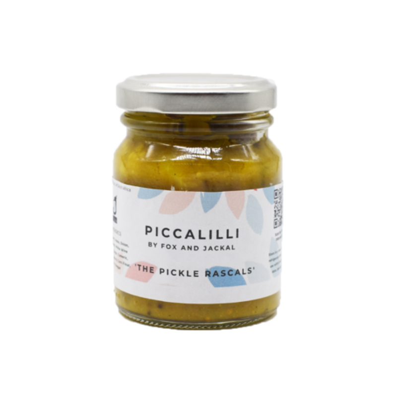 A jar of Fox & Jackal Piccalilli, the pickle relish, with a colorful label showing floral patterns and product details.