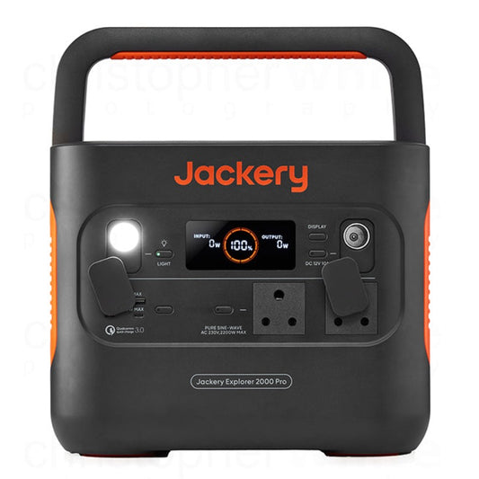 A portable power station with Jackery branding, featuring multiple power outlets, a carrying handle, and a digital display.