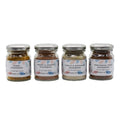 Four jars of Fox & Jackal Seasoning Collection, each with a different label indicating the flavor of the seasoning, from left to right: Curry, Garlic & Rosemary, Provençal Herb, and Sweet & Smoky.