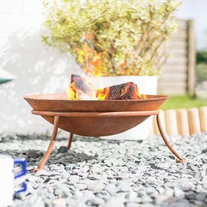 Oxidised steel fire pit with flames in a garden setting