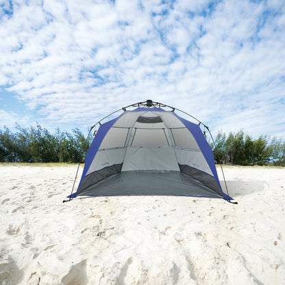 Camping tent on a sandy beach with a blue sky and clouds