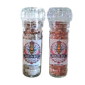 Two glass grinders labeled Queen Bee Chilli Creations, one with Habanero Salt and the other with Reaper Salt, against a white background.
