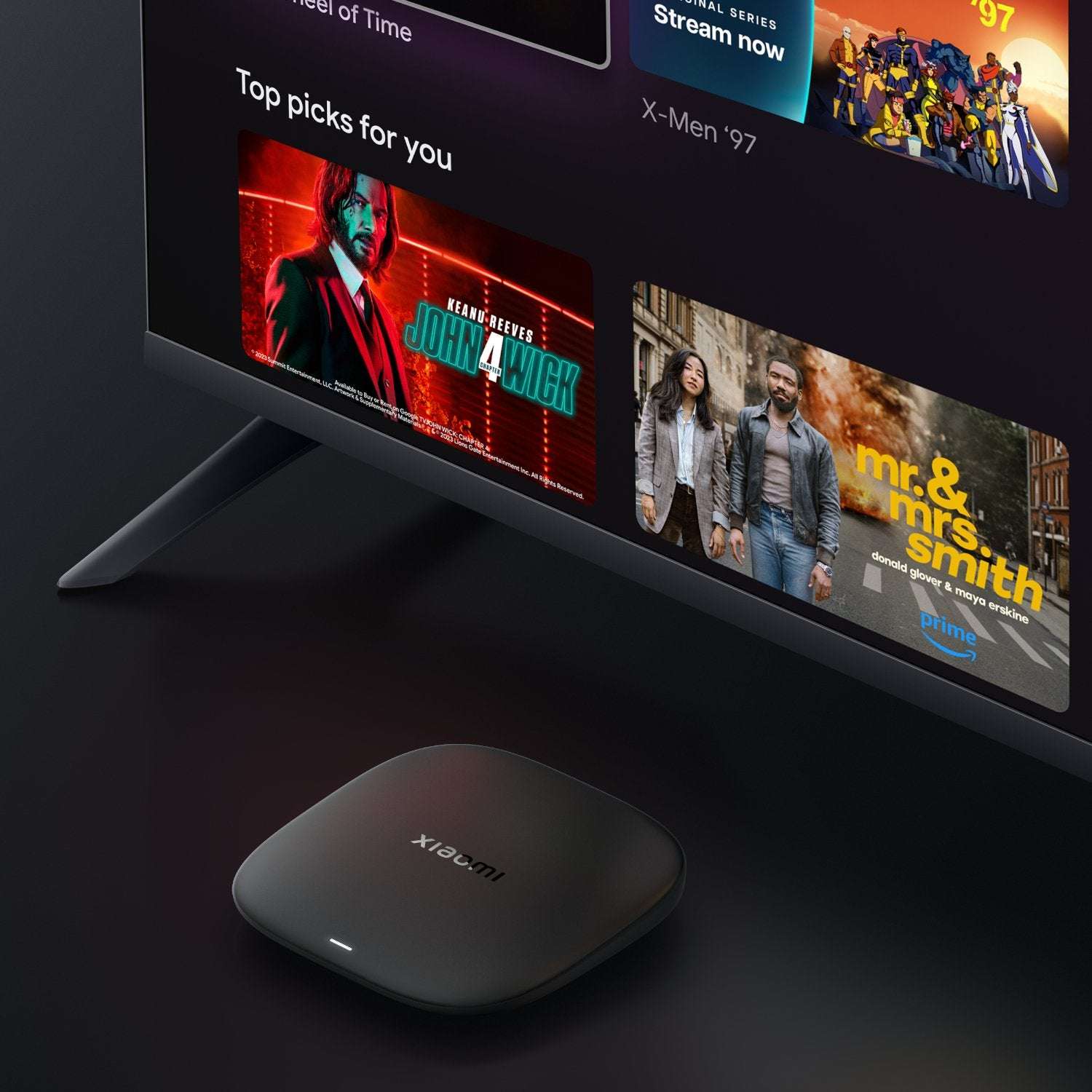 Smart TV displaying movie posters with a Xiaomi device in front.