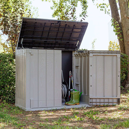 Outdoor storage shed with tools and equipment inside, surrounded by trees and greenery.