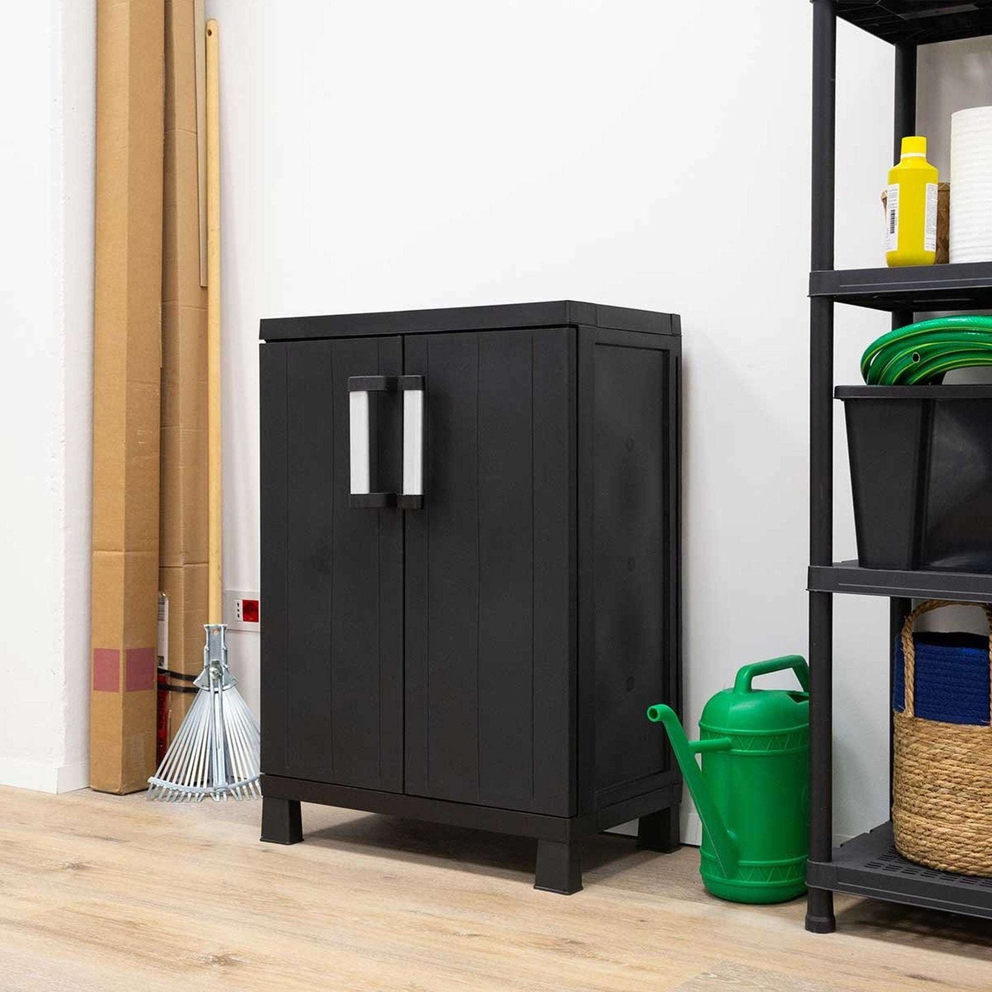 Black storage cabinet in a room with cleaning supplies