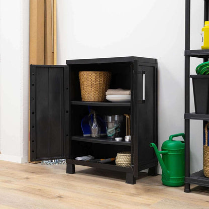 Black storage cabinet with open door on a wooden floor, containing various items.