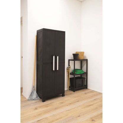 Black storage cabinet in a room with a rake and small shelf.