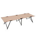 Beige camping cot with black legs and orange accents on a white background