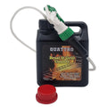 A black bottle of Quattro Braai & Grill Cleaner with a green and white spray nozzle attached, and a red cap lying next to it.