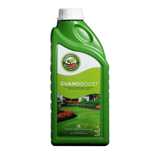 A green bottle of GuanoBoost liquid organic fertilizer with a white cap. The label includes a picture of a lush garden and the product name.