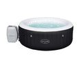 An inflatable hot tub with a black exterior and white interior, featuring a circular design and labeled as 'Lay-Z-Spa'.