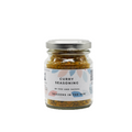 A glass jar containing Fox & Jackal Curry Seasoning. The label on the jar indicates that the product is gluten-free, vegan, and suitable for vegetarians and vegans.
