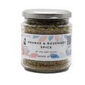 A glass jar containing Fox & Jackal Orange & Rosemary Spice with a label on the front displaying the product name and branding.